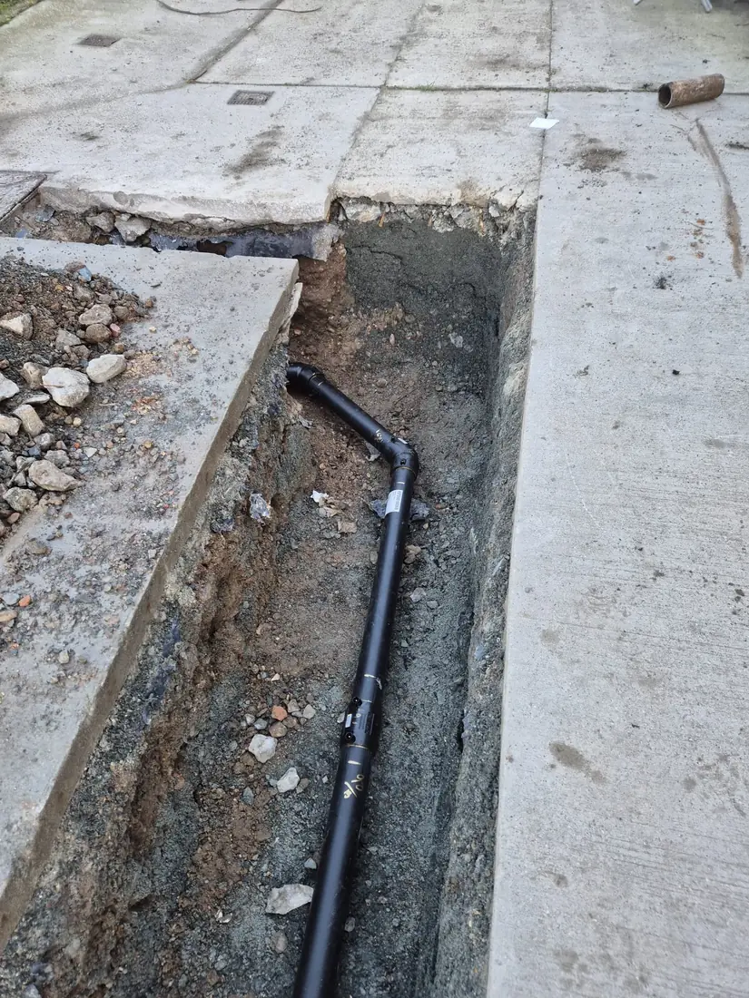 Blue ductile-iron water main and valve assembly in an open trench
