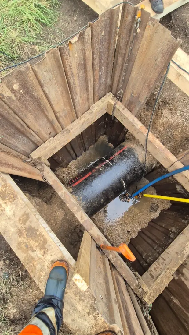 Mini-excavator trenching for a new supply