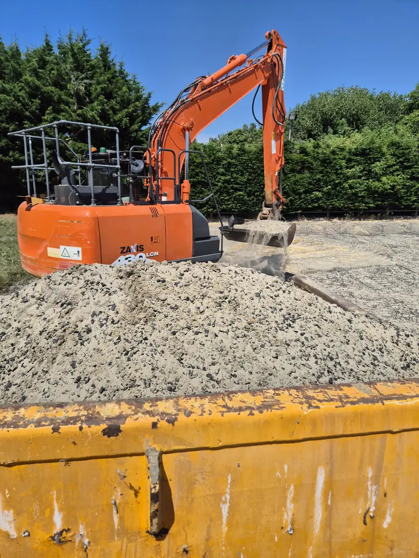 Excavator digging a service trench on a Malling Utilities site