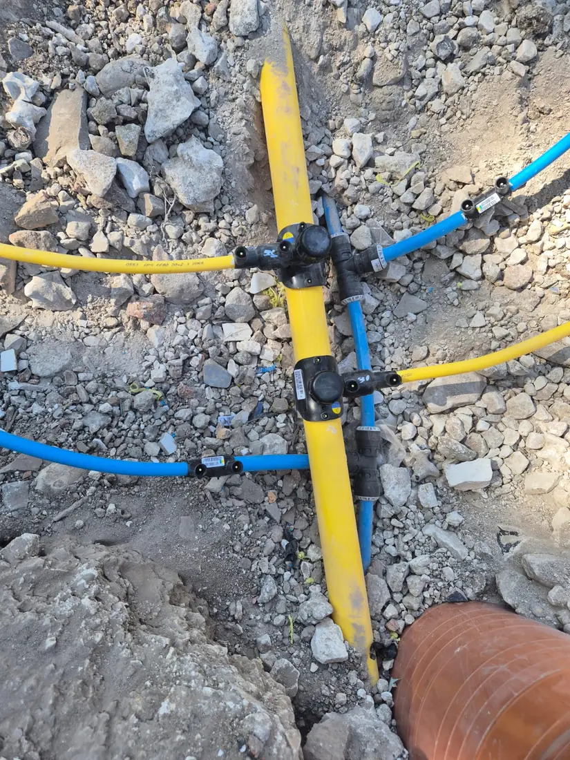 Water and gas service pipes to a meter box