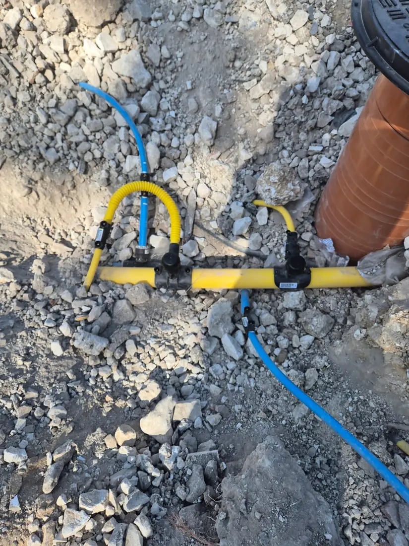 Water and gas service pipes to a meter box